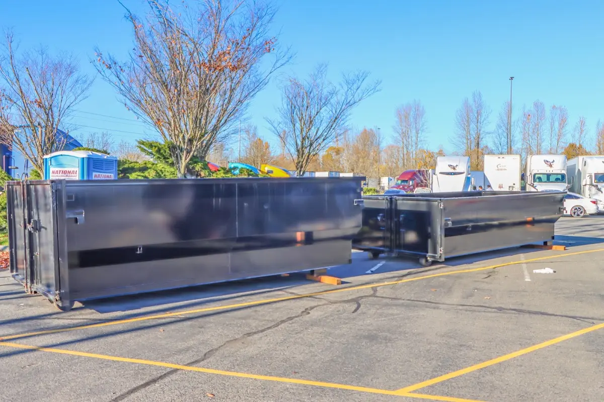 Professional dumpster rental service with roll-off container on residential driveway in Upper Hanover